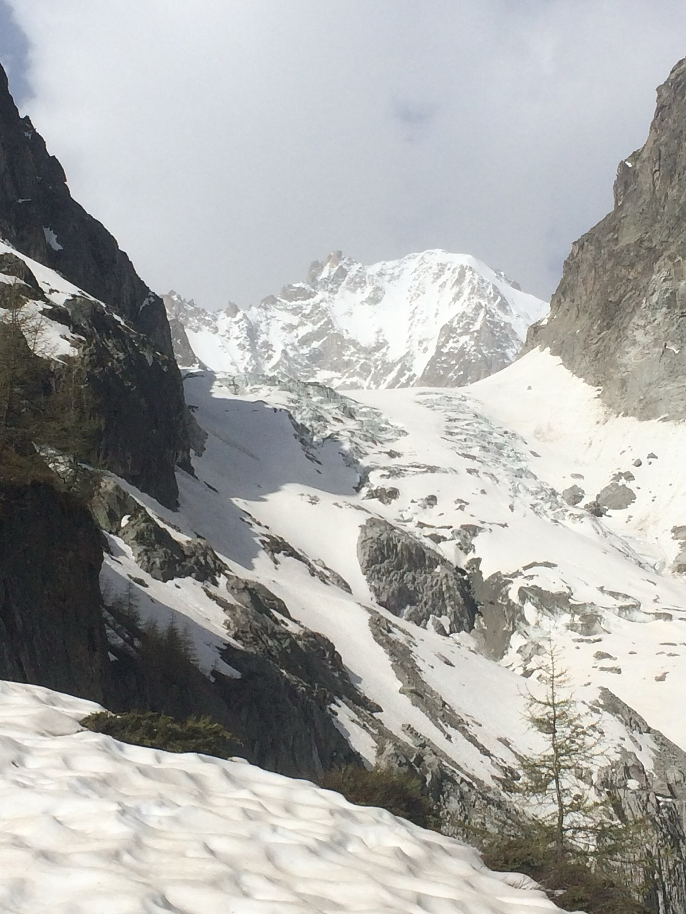 Close view of the rocky summit of Aiguille du Chardonnet above snow and glacier ice