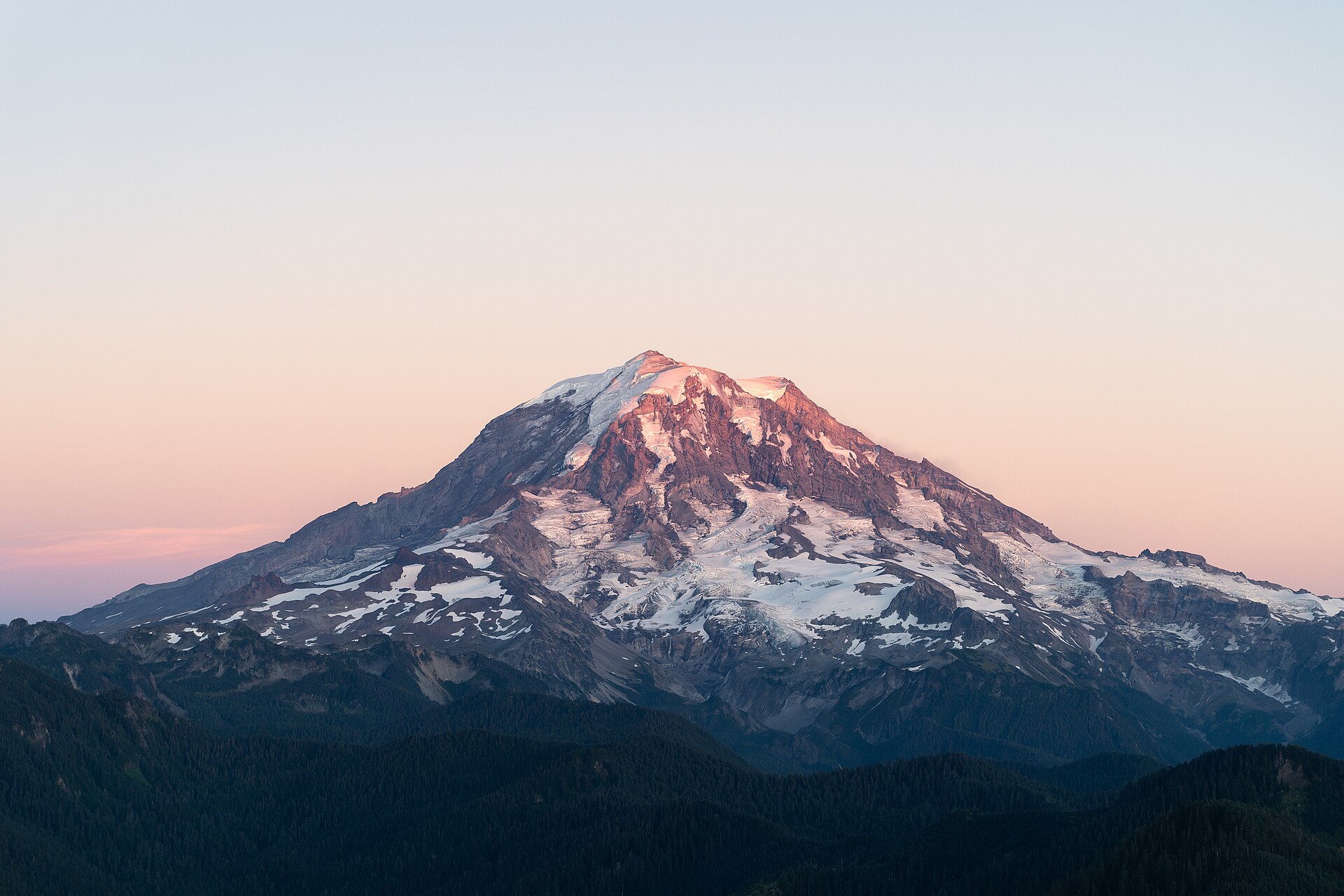Mount Rainier (also known as Tahoma or Tacoma) glows blue and red on the evening of September 6th, 2020. This is the northwestern slope seen from the window of a Cessna 172. The mountain's snow and ice are low at the end of the summer.